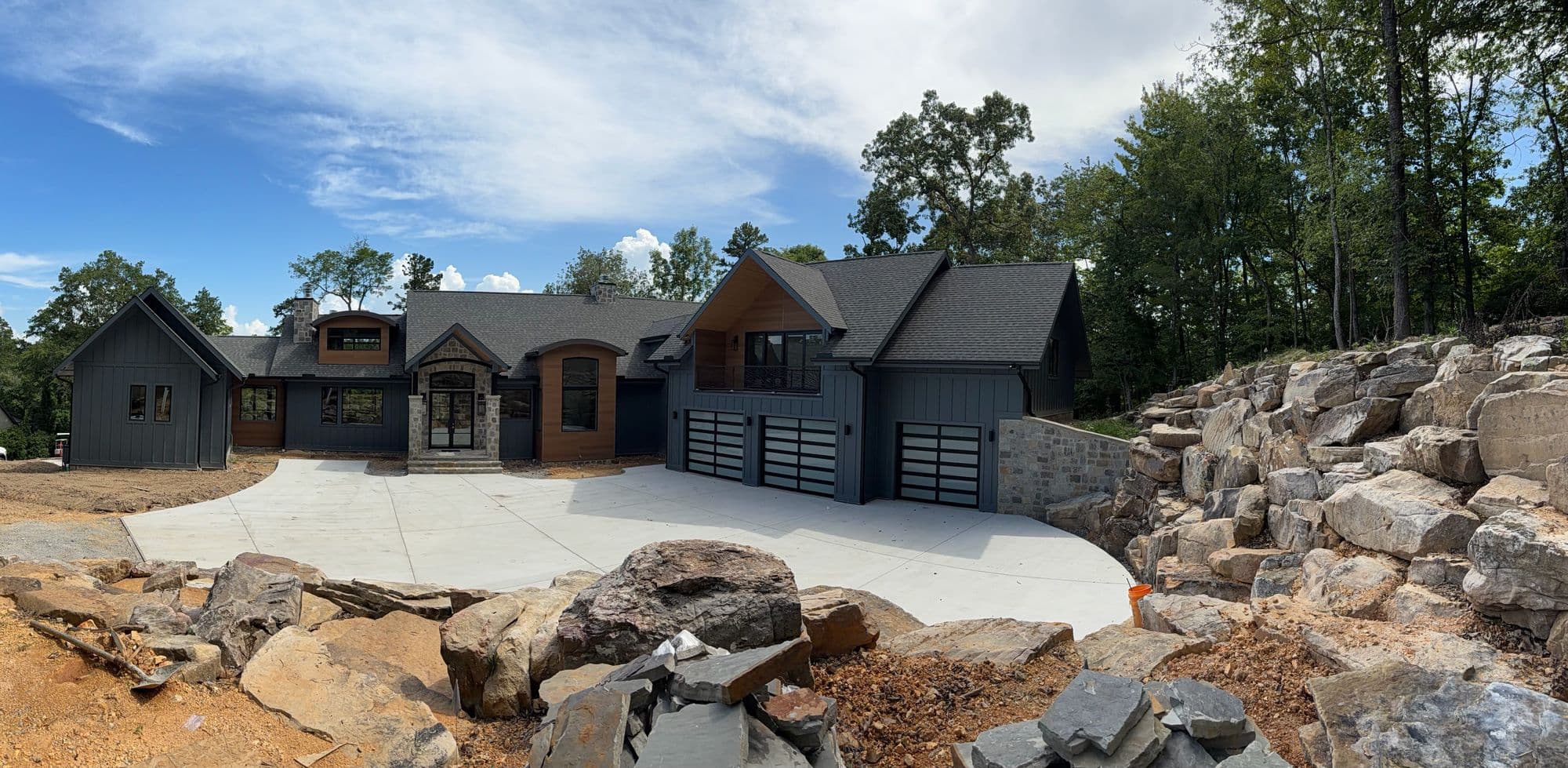 Custom home in stone and timber with attached garage, built by Tim Stover Construction