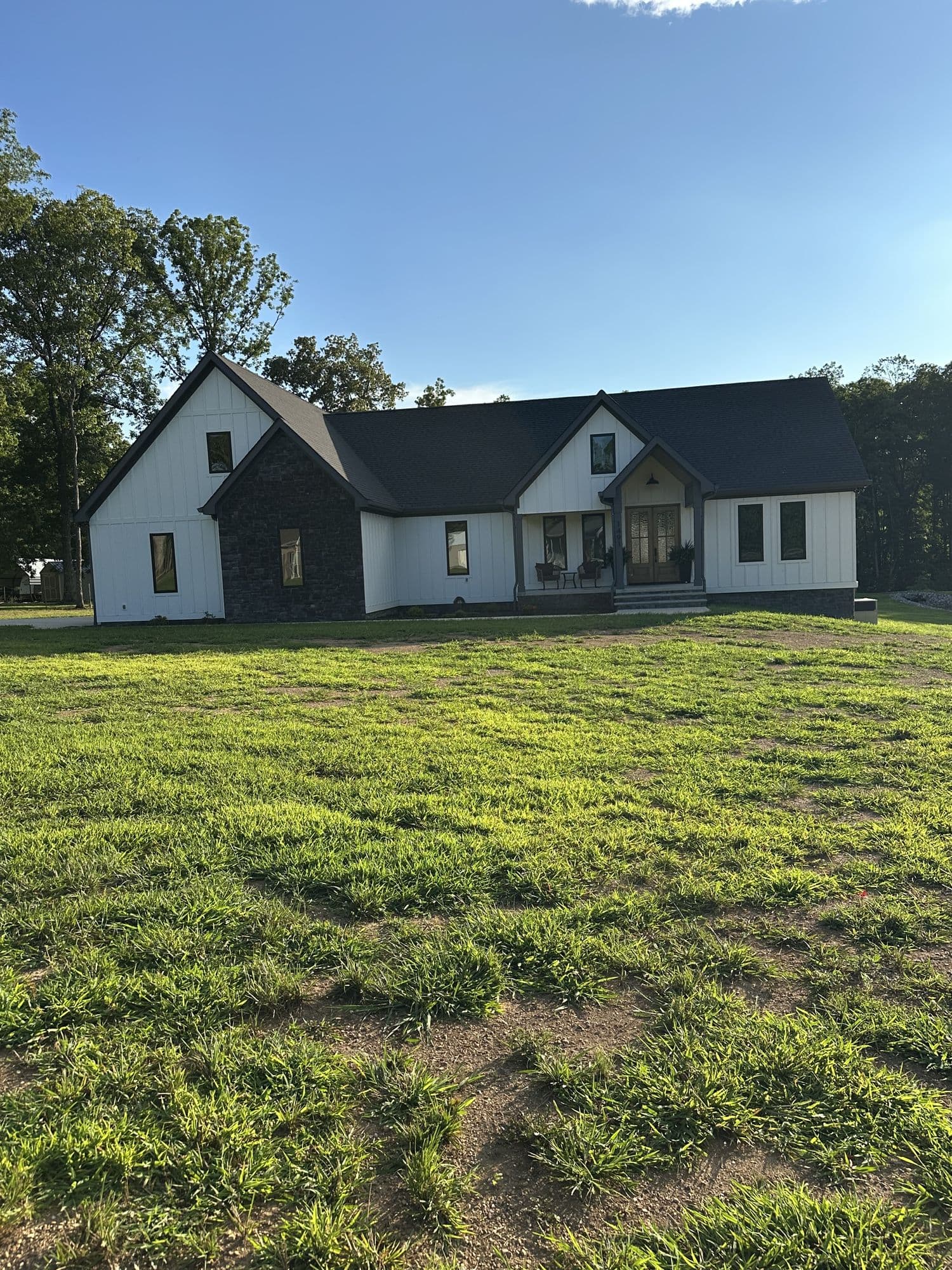 Board-and-batten farmhouse exterior with black metal roof