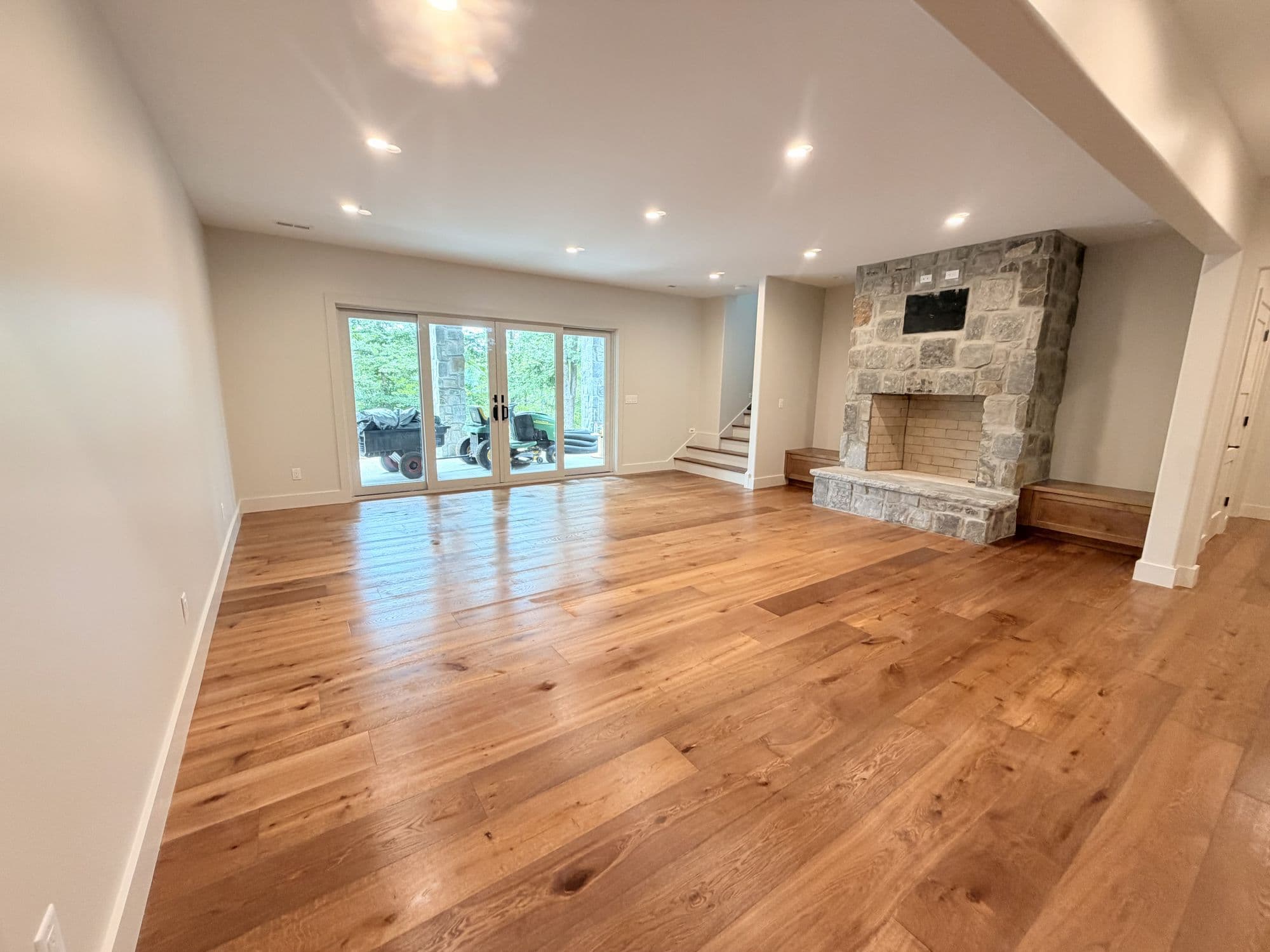 Open living room in white oak with a stone fireplace